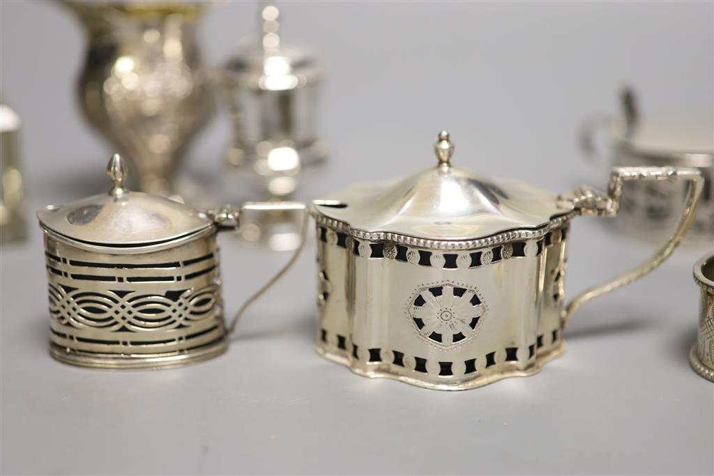 A collection of small silver items, comprising a George III helmet-shaped embossed cream jug,